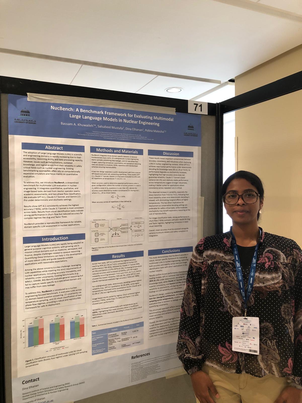 A picture of me (Dina Elhanan) standing in front of my research poster presenting my group's research article NucBench: A Benchmark Framework for Evaluating Multimodal Large Language Models in Nuclear Engineering. This was during the poster session on April 22, 2026 as part of PHYSOR'26.